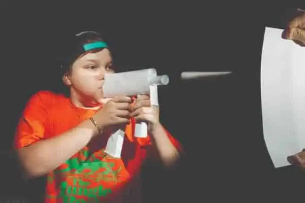 Ben blowing paper gun