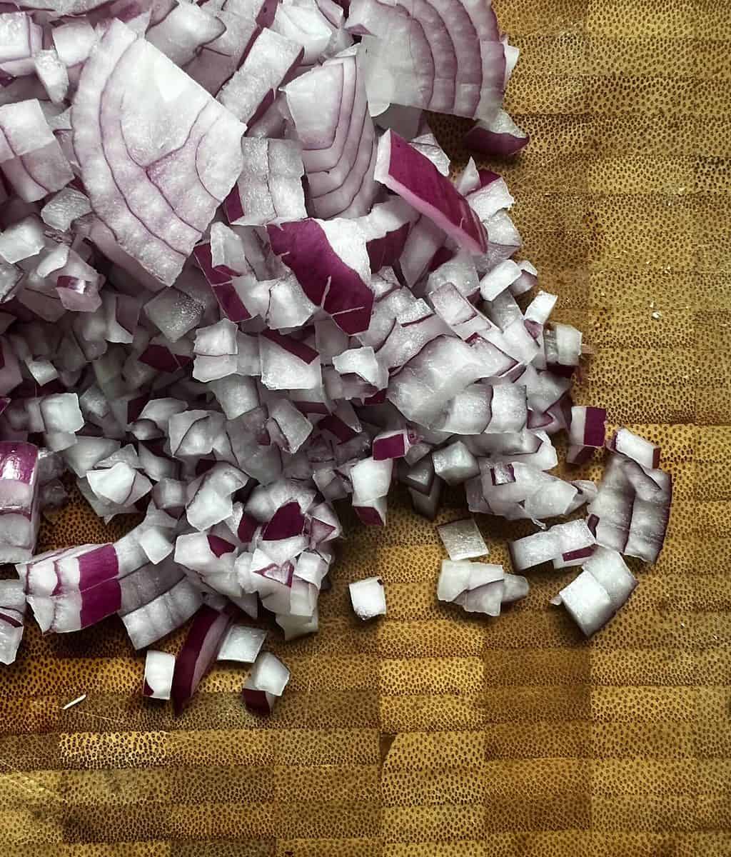 Cutting board full of diced red onion