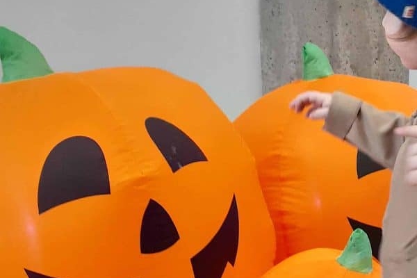 A boy and inflatable pumpkin