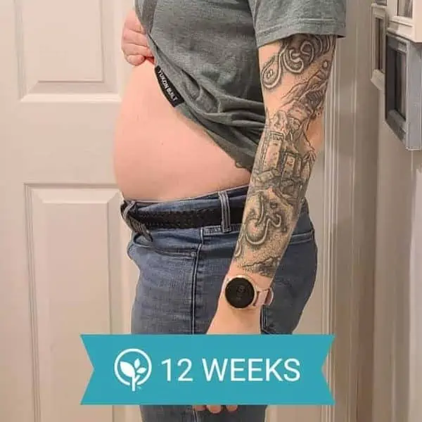 A woman showing her 12-week pregnancy