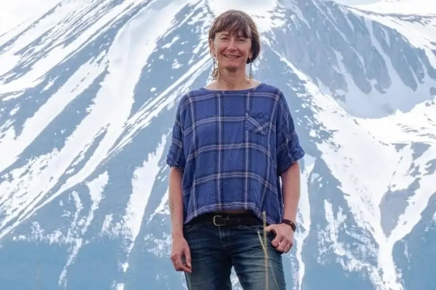 A woman standing in front of the mountains
