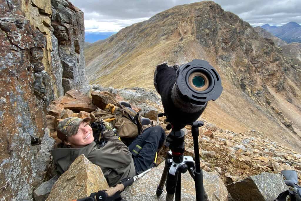 A woman with binoculars on a mountain