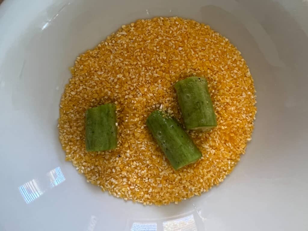 Dip okra in egg, then in cornmeal