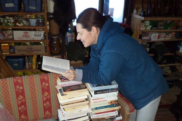 A woman with a stack of books