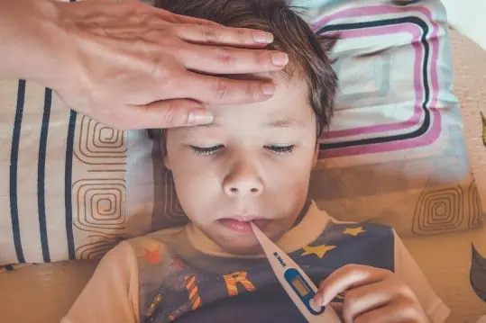 A sick child with thermometer