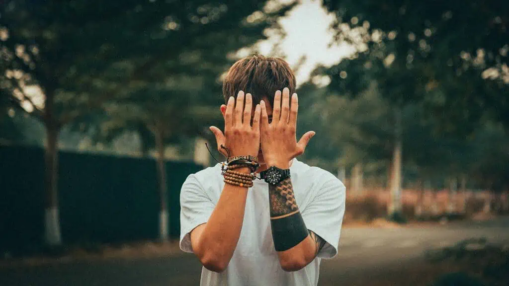 A man covering his face