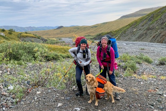 Two hikers with a dog