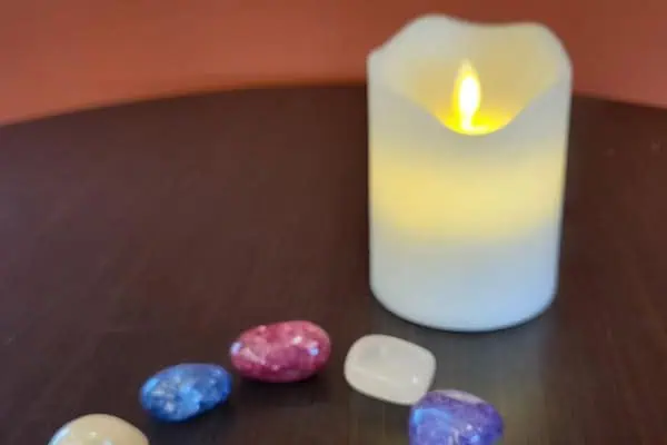 Beautiful stones around a candle visually represent a group having enlightened discussions