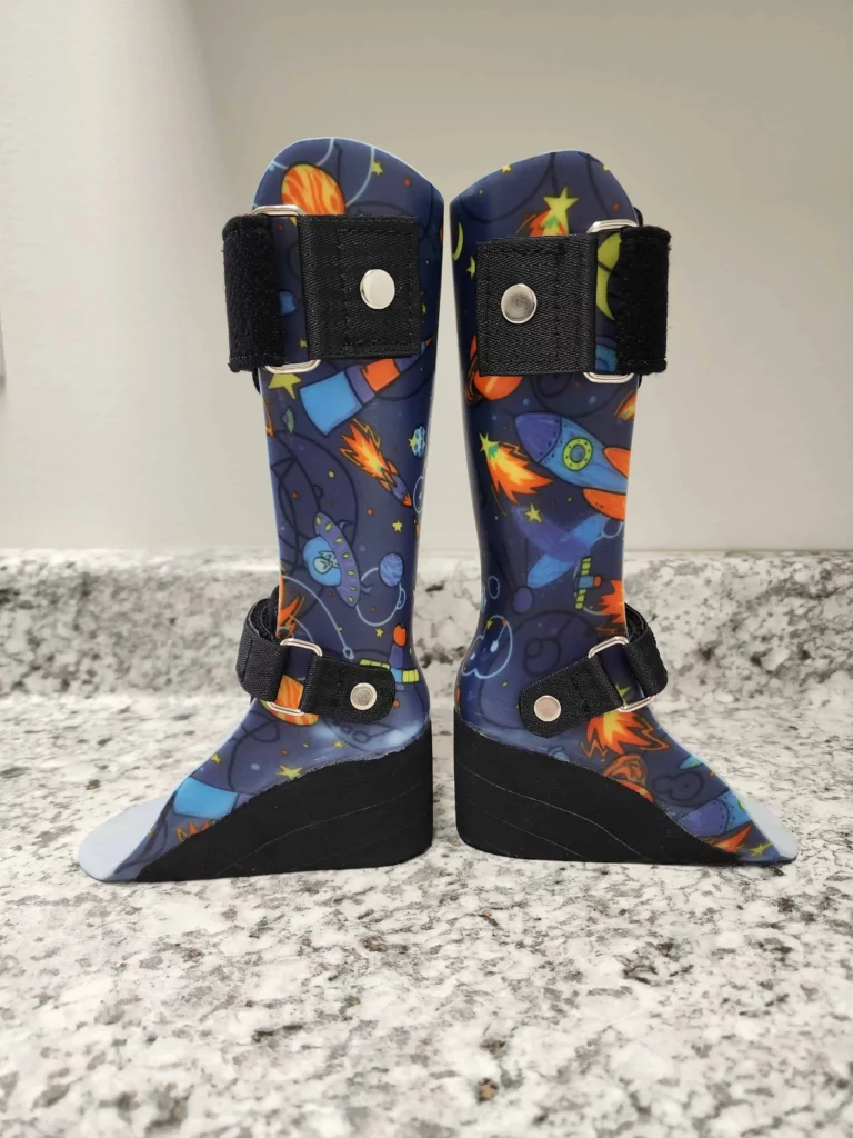 Pediatric ankle-foot orthotic with rocket ships and UFOs